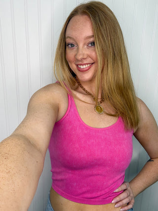 Bright fuchsia ribbed seamless tank top with scoop neckline on model.
