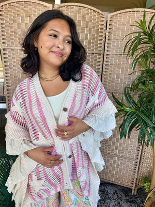 Oversized cream and pink striped cardigan with textured knit pattern and button front closure.
