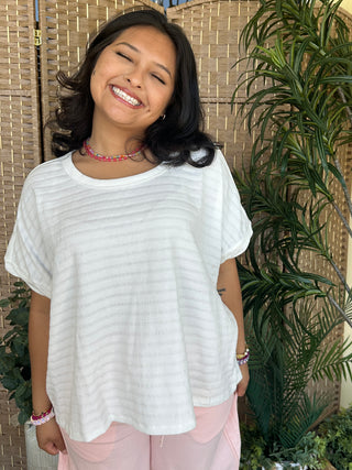 White textured dolman top with short sleeves and relaxed fit.

