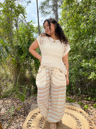 Cream crochet tank top paired with aqua and peach geometric patterned wide-leg pants.
