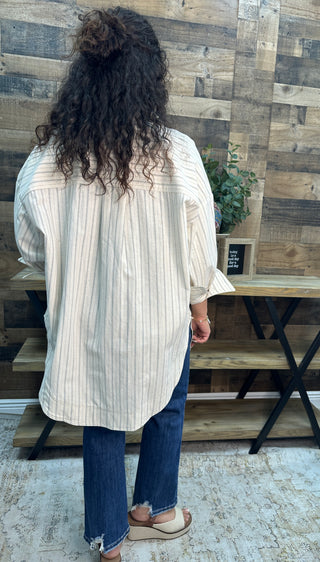 Ivory and black striped button-down shirt worn oversized, back view.
