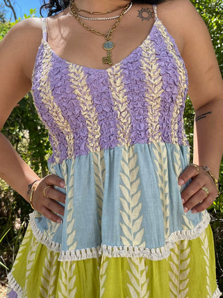 Purple and lime tiered maxi dress with ruched bodice, leaf print, and fringe trim details.
