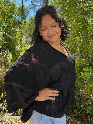 Black lace handkerchief top with sheer overlay and flutter sleeves.

