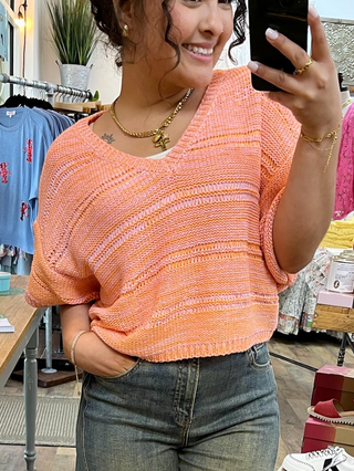 Coral textured crochet short-sleeve top with horizontal stripe detail and crew neckline.
