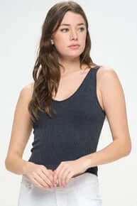 Ribbed black reversible seamless tank top on a clothes hanger, highlighting its versatile design and texture.