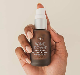 FHF Wine Down® Overnight Serum in a purple bottle, enhancing nighttime skincare routine with potent antioxidants.