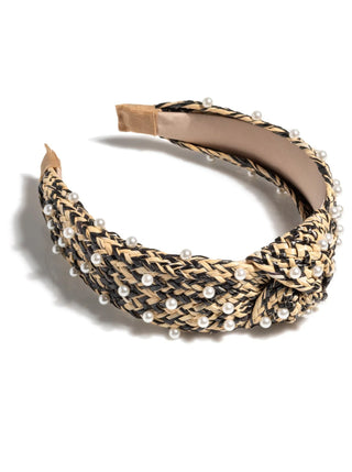 Black and tan woven raffia headband with pearl beads and twisted knot detail.
