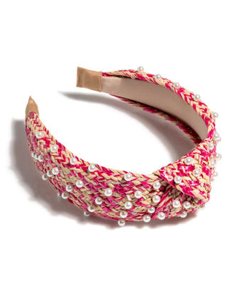 Hot pink and cream raffia headband with pearl beading and twisted knot detail.
