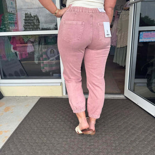 Stylish MICA Denim Dusty Rose Jogger Jeans with elastic waistband and cuffed ankles, perfect for casual chic outfits.