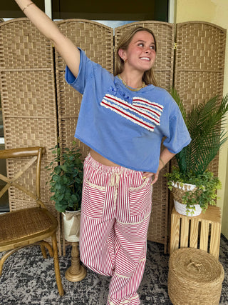 Oversized blue tee with red and white striped graphic, paired with red and white striped pants.
