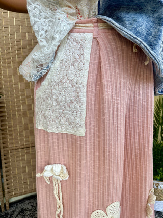 Blush pink ribbed joggers with cream embroidered leaf details and drawstring waistband.