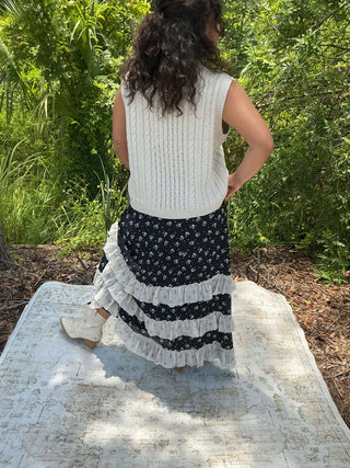Bone cable knit sweater vest with a tie front detail, perfect for layering or a stylish standalone look