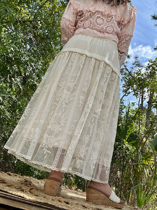 Ivory embroidered maxi skirt with floral sheer overlay and ruched waistband.
