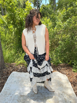 Navy floral maxi skirt with ivory ruffles, featuring a flowing design and elegant pattern