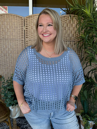 Blue openwork dolman top with geometric eyelet pattern and short sleeves.
