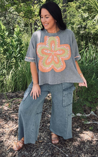 Mineral washed blue short sleeve top with vibrant orange flower patch by Easel, perfect for a casual and chic look.