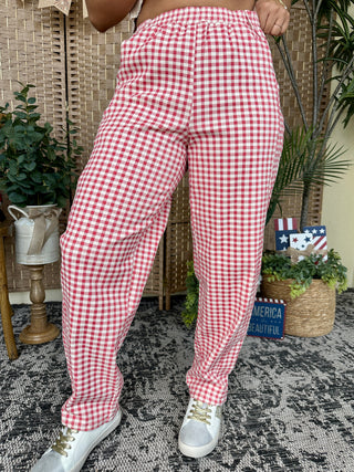 Red and white gingham check pants with relaxed gypsy fit, worn with white sneakers.
