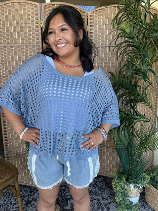 Blue crochet dolman top with short sleeves and openwork pattern detail.
