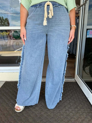 Light denim vintage wash straight leg pants with fringe trim by NoaBoa, showcased against a plain white background.