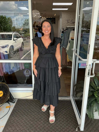 Elegant &Merci black V-neck tiered ruffle midi dress, perfect for chic occasions and sophisticated style.