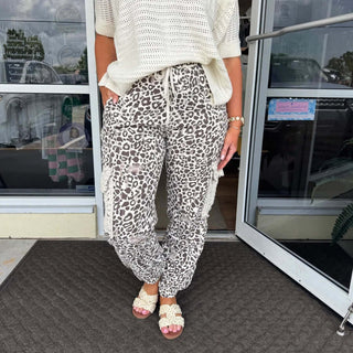 Alt text: "POL Cream Choco Leopard Distressed Jogger Pants with an edgy design and comfortable fit.