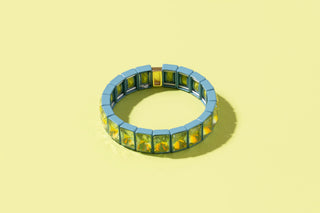 Blue and chartreuse stretch bracelet with square gemstone panels on yellow background.
