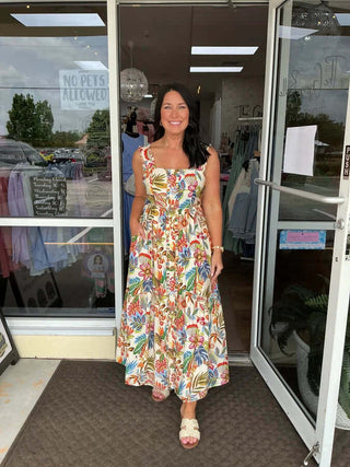 Alt Text: "Elegant cream tropical floral pleated shoulder midi dress for a stylish, breezy look.