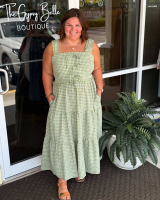 Model wearing Lt Olive Gingham Tie Front Scalloped Trim Midi Dress by Oddi, featuring a stylish and feminine silhouette.