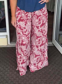 Red paisley print side-tie wide-leg pants on final sale, showcasing vibrant patterns and stylish comfort for a trendy look.