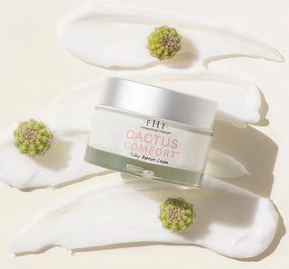Cactus Comfort silky barrier cream jar surrounded by cactus flowers and white product swatches on cream background.
