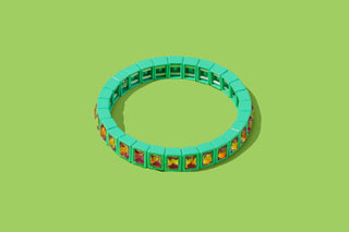Mint green stretch bracelet with colorful gemstone accents and grid detailing.