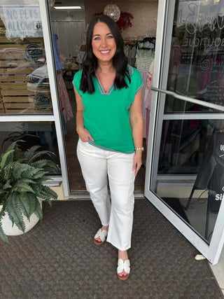 Alt text: "Green sailor neck sleeveless top with pink trim, ideal for summer fashion and casual chic looks.