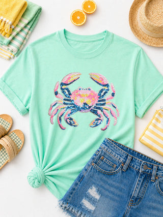 Mint green t-shirt with colorful sequin crab design on chest.
