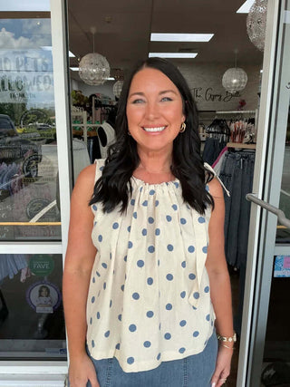 Stylish polka dot sleeveless top with drawstring neckline, available in two colors, by Adora. Ideal for any occasion.