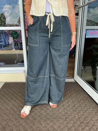 Alt text: "Dark denim wide leg drawstring pants by Listicle with relaxed fit, showcased in a stylish flat-lay image.