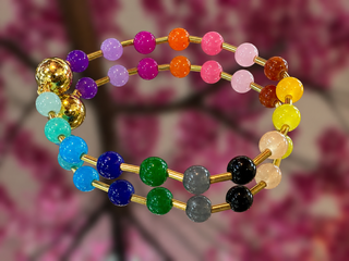 Colorful glass bead bracelet with rainbow gemstones including purple, pink, orange, yellow, blue, green, and black beads on g
