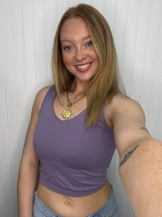 Dusty purple seamless tank top on model, paired with gold pendant necklace.
