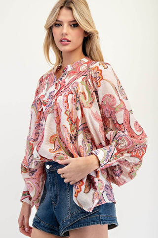 Pink paisley print top with long bubble sleeves, perfect for a stylish, casual look. Tailored fit with vibrant patterns.