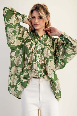 Emerald Green Jacquard Print Long Bubble Sleeve Top on a hanger, showing intricate patterns and rich fabric texture.