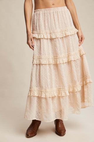 Listicle Ecru Maxi Skirt with Tufted Dot Lace Tiers elegantly displayed on a mannequin, highlighting its intricate details.