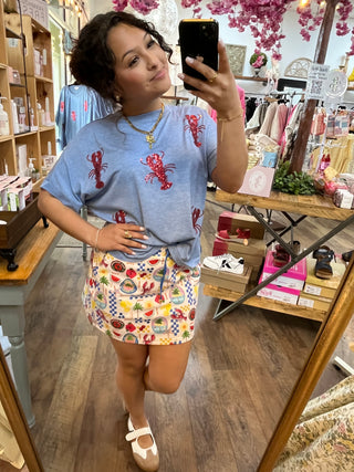 Light blue t-shirt with red sequin lobster print pattern.
