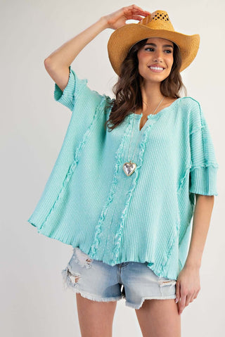 Alt text: "Stylish Easel Top Short Sleeve Textured Rib Oversized Blouse in Cream and Olive Green, perfect for a modern casual look.