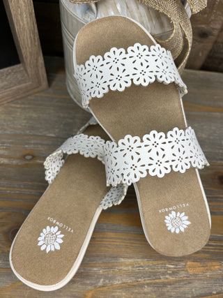 White scalloped eyelet sandals with tan suede footbed and daisy embroidery detail.

