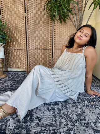 Light blue sleeveless double layer top with striped detail, worn as relaxed fit dress.
