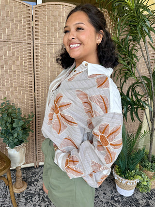 White button-down shirt with orange floral stripe pattern and white collar.
