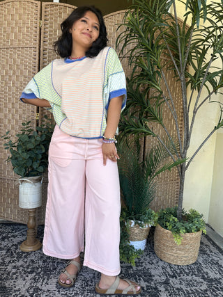 Striped dolman top in coral, green, and blue with blue trim on sleeves and neckline.
