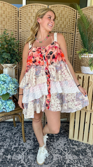 Sleeveless floral print swing dress with peach poppy top and cream floral lace bottom layers.
