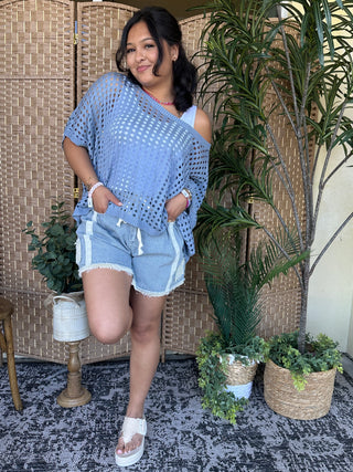 Blue mesh dolman top with textured dot pattern and cold-shoulder design.
