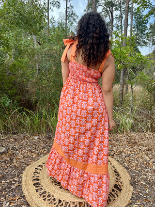 Orange damask print sleeveless maxi dress with shoulder ties and pintuck detailing.

