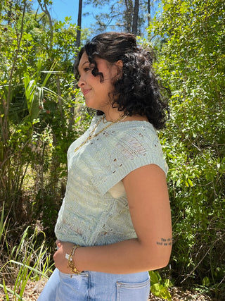 Pistachio crochet short-sleeve top with textured knit pattern and cutout detail.
